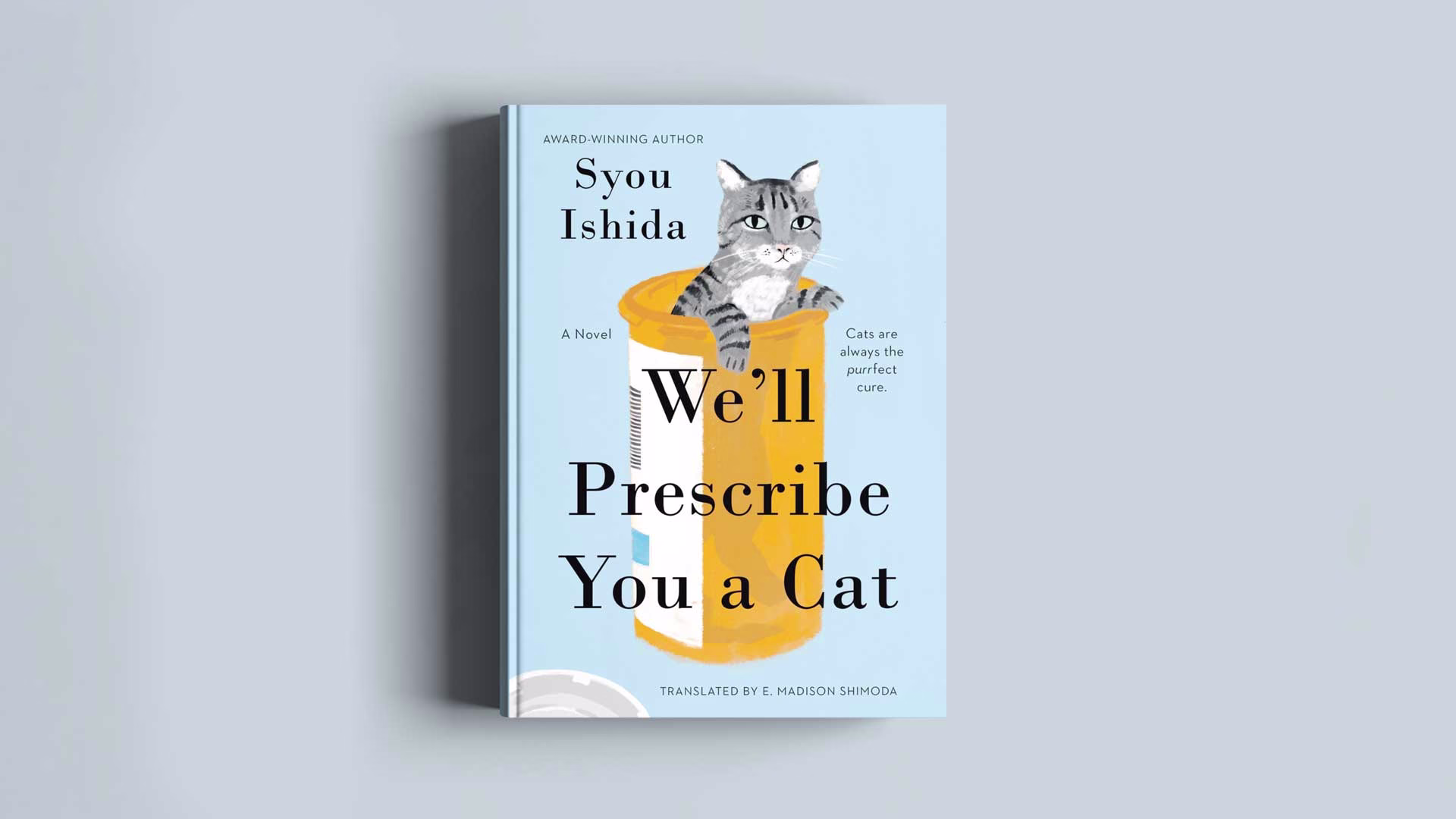 Image showing the front cover of the book "We'll Prescribe You A Cat" by Syou Ishida on a light gray background.